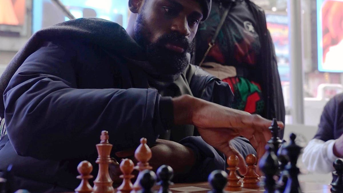 Tunde Onakoya playing chess in Times Square as part of his attempt to break the record for the longest chess marathon