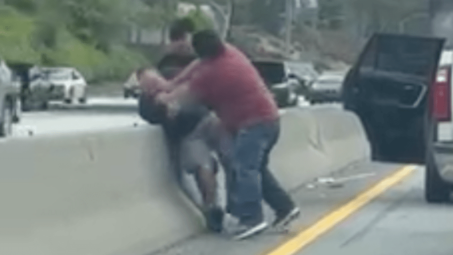 A motorist is seen being held and punched by two people on the 10 Freeway in Santa Monica on April 23, 2024.