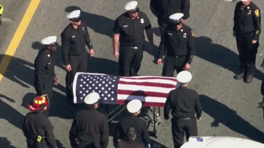 A U.S. Flag is draped over the body of a Los Angeles Fire Department recruit firefighter who was killed on the 101 Freeway on April 15, 2024.