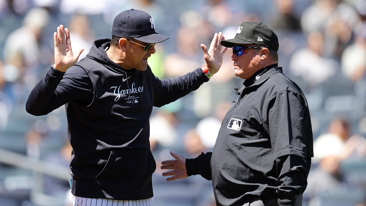 Aaron Boone #17 of the New York Yankees argues with third base umpire Marvin Hudson #51 in the first inning during the game against the Oakland Athletics at Yankee Stadium on April 22, 2024 in New York City.
